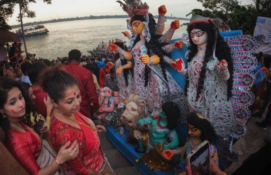 people standing around a float with dolls on it in India