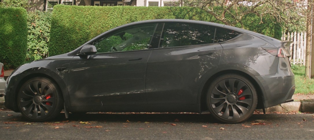 Grey Tesla on side of road